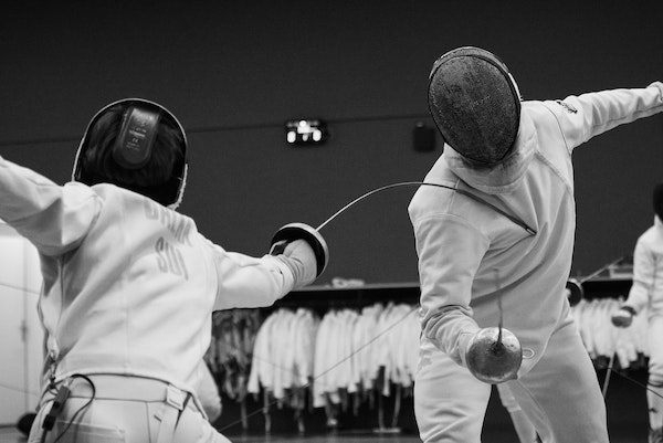 Two people fencing (black & white)